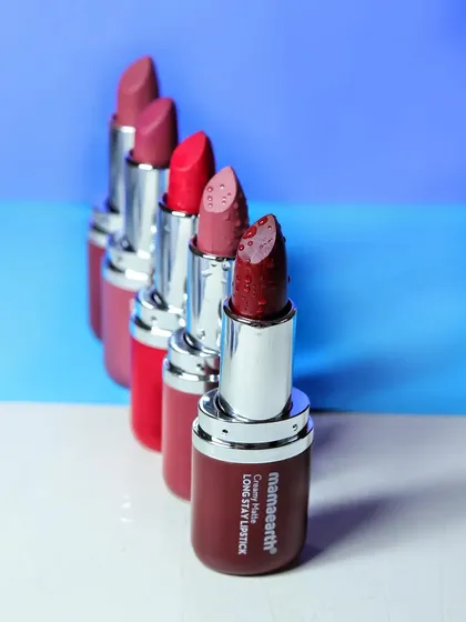 An organized lineup of five Mamaearth lipstick shades, arranged to showcase the color gradient from deep reds to softer pinks.