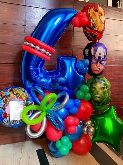 An Avengers-themed balloon bouquet for a 4th birthday party. I included foil balloons of Captain America, Iron Man, and the Hulk, combined with a large number "4" and other coordinating colors.