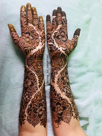 A gorgeous full-arm design with a flowing floral vine pattern. The negative space makes the intricate details pop.