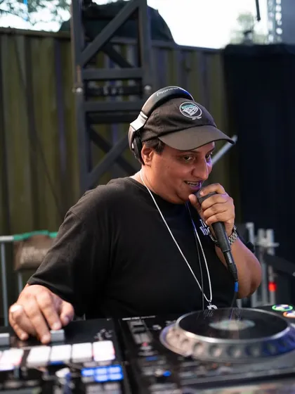 Behind the decks is my home. Here I am on the mic, hyping the crowd and mixing tracks at The Sultan Room. It's not just about playing music; it's about hosting the party and making sure everyone feels the vibe.