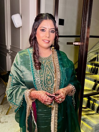 Skin first, makeup second, confidence always. A beautiful, natural look for this guest in a stunning green suit.