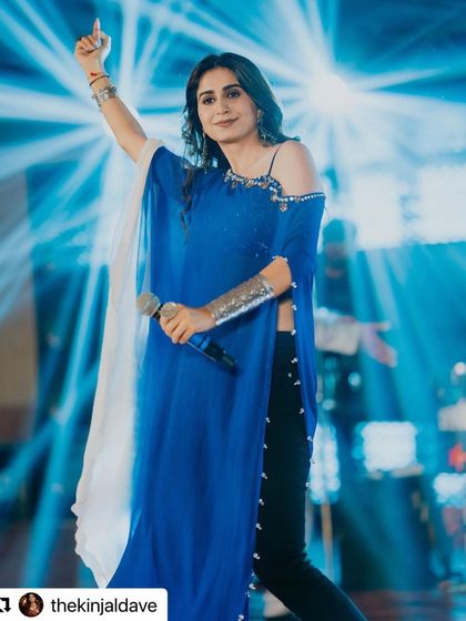 Kinjal Dave owning the stage. The silver oxidised jewellery adds a touch of bohemian flair to her modern blue outfit, showing the versatility of these pieces for festive and performance wear.