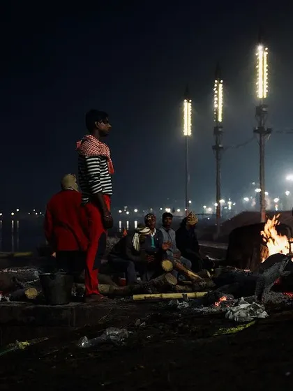Under the cover of night at Manikarnika Ghat in Varanasi, funeral pyres burn brightly against the dark waters of the Ganges. My approach to documenting these sacred rites is quiet and respectful, focusing on the atmospheric reality of the scene.