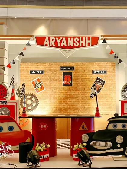 This 'Two Fast' Cars-themed party was all about the details. I created a custom pit stop for the birthday boy, complete with character cutouts of Lightning McQueen, themed props, and a backdrop that puts you right in the middle of the race.