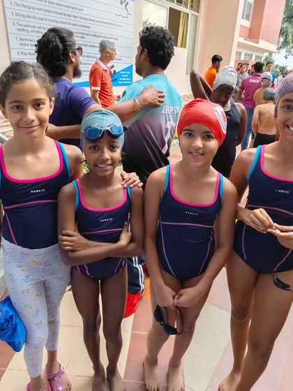 Our girls' relay team, ready to race. Team events are a highlight of any swim meet, requiring coordination, speed, and trust in your teammates.