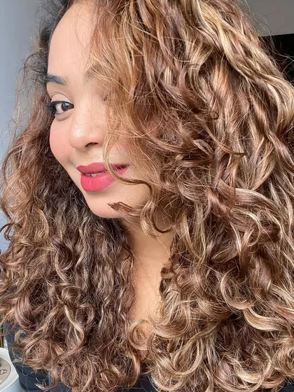 A close-up of my curls. Healthy hair doesn't mean zero frizz. It means embracing your hair's natural state.