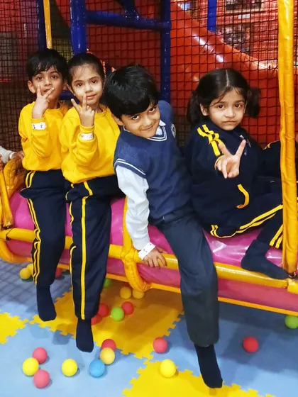 A group of students in their school uniforms having a great time on the swinging log ride. It's a fun activity that encourages cooperation.