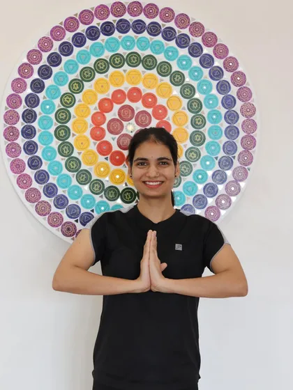 Meet one of our inspiring trainers, standing before our chakra-inspired mandala. Our trainers are your motivators, mentors, and sources of inspiration on your wellness journey.