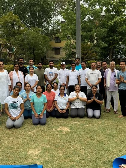 A group photo with participants after an International Yoga Day session. The shloka "Lokah Samastah Sukhino Bhavantu" is a prayer for all beings everywhere to be happy and free.