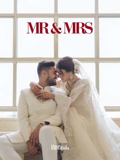 Mr. & Mrs. A beautifully lit portrait of the newlyweds, capturing an intimate moment of connection and joy against a bright, airy window.
