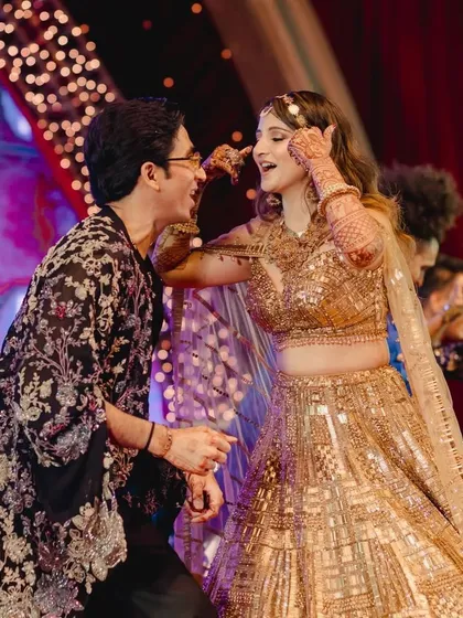 A playful dance moment between the bride and a family member, full of laughter and fun.