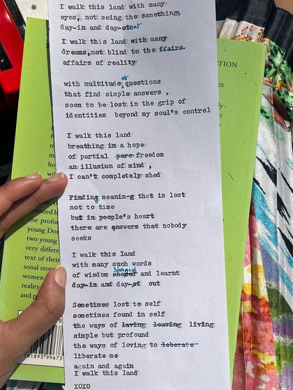 A close-up of a poem typed on my typewriter, resting on a book. This image captures the two worlds of my literary life: the reading and the writing, both essential to my creative process.