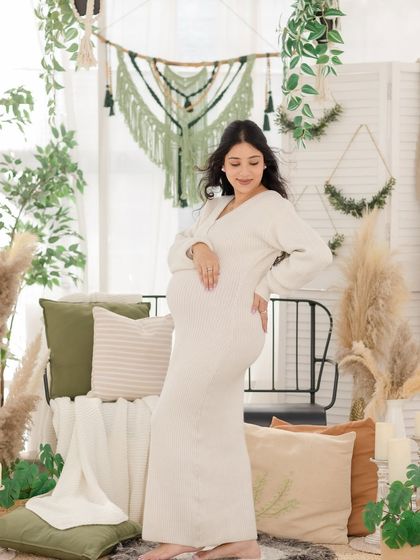 A serene moment in our cozy, boho-themed greenhouse set. The natural textures, soft light, and earthy tones create a warm and tranquil atmosphere for maternity portraits.