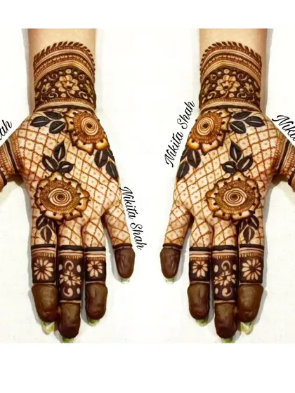 A lovely Indo-Western design with floral motifs on a net background. The dark leaves create a beautiful contrast.