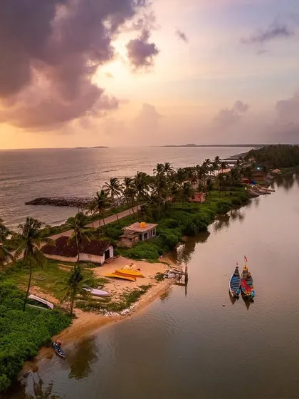 A monsoon sunset over the unique landscape where a river and the sea run side-by-side. The dramatic clouds add to the beauty of the scene.