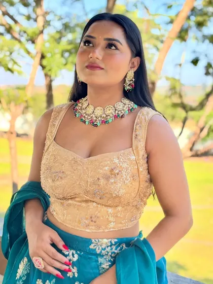 Looking up with a smile, feeling the festive energy. This outfit is ideal for an outdoor wedding carnival or Mehendi ceremony, combining traditional embroidery with a modern silhouette.