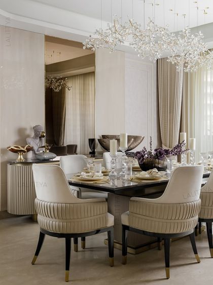 A view of one of our elegantly styled dining rooms. We focus on combining statement lighting, comfortable seating, and high-quality materials like marble and brass to create spaces that are perfect for both everyday meals and special occasions.