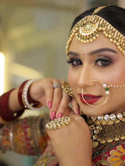 A stunning close-up of a bride, highlighting her intricate matha patti and bold makeup. This shot is all about bridal beauty.