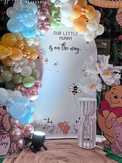 Another version of our Winnie the Pooh baby shower theme, this time with a multi-colored pastel balloon arch.