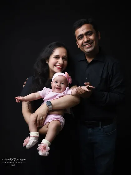 A lovely portrait of a mother and father with their baby girl. The mother holding the baby creates a slightly different dynamic and a beautiful "Mumma and me" moment within the family photo.
