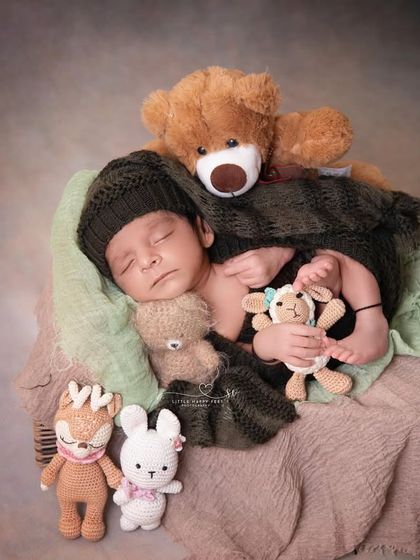 Surrounded by his entire collection of stuffed animals, this little boy is clearly so loved. It's a sweet way to incorporate a child's favorite toys into their first photoshoot.
