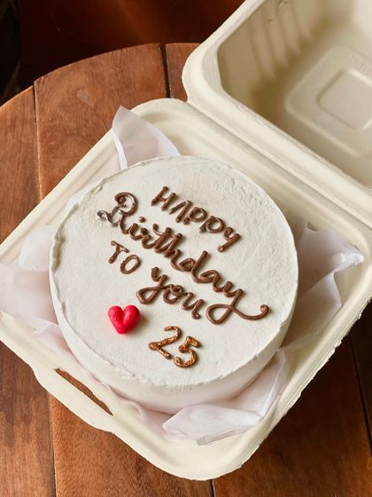 A classic and simple birthday bento cake. The white frosting provides a clean canvas for the "Happy Birthday to you" message, with the age "25" and a single red heart.