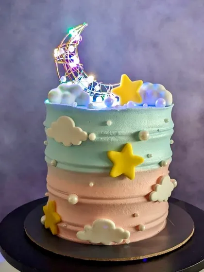 This baby shower cake lights up. The moon topper has LED lights, adding a magical twinkle to your celebration.