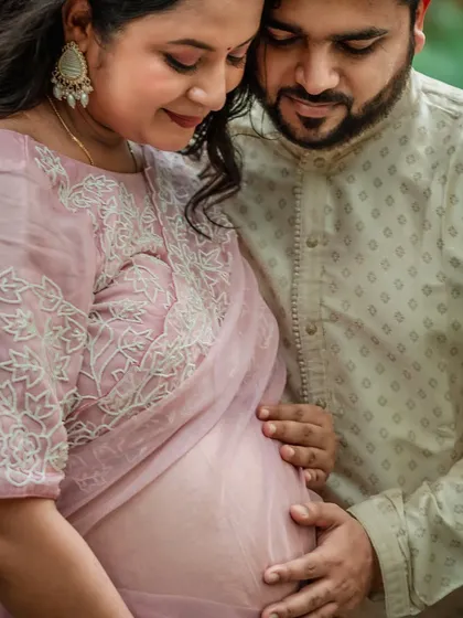 Sometimes, the most powerful stories are told in the quietest details. This intimate close-up shows a couple's hands gently holding the baby bump, a simple gesture that speaks volumes about their shared love and anticipation.