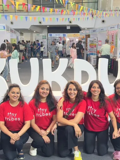 Our amazing team posing proudly in front of the Kukdukoo Fest sign. I started this journey alone 15 years ago, and seeing our tribe grow fills me with so much pride. These are the passionate educators who make it all possible.