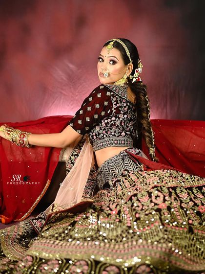 A confident over-the-shoulder look from the bride, showcasing her braided hairstyle and the back of her blouse.