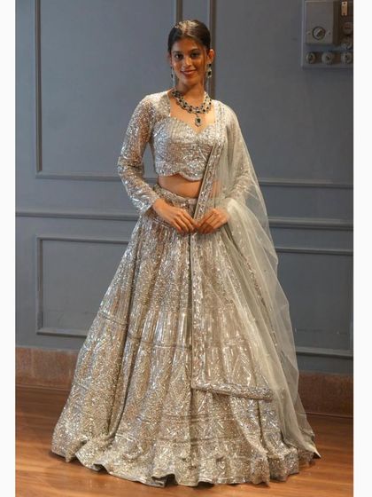 Another shot of our sparkling silver lehenga, showing how it catches the light beautifully. A true showstopper for any reception or party.