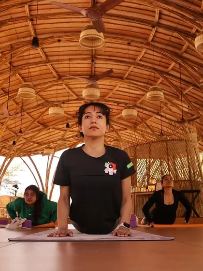 In our morning retreat sessions, we move with intention. Here, a student embodies strength and focus in Bhujangasana (Cobra Pose) in our beautiful bamboo shala, surrounded by the sounds of nature.