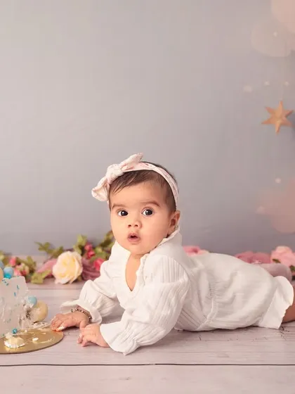Exploring her first little cake. Even for a six-month session, a small cake can be a fun prop for your baby to interact with.