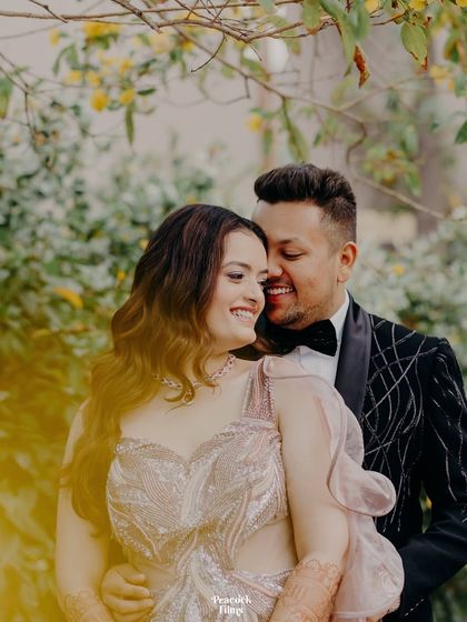 A beautiful, sun-kissed portrait of the couple. Their joyful interaction and the warm light create a magical and romantic atmosphere.