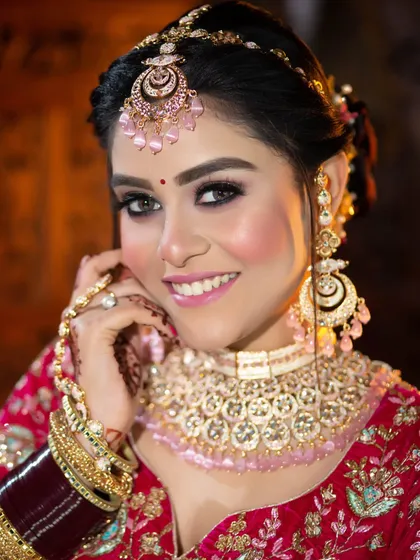 A happy, smiling bride. This look features a classic smokey eye and a bright pink smile, a perfect combination of glam and joy.
