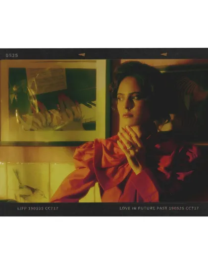 A film-strip style image from Chapter 4. The red blouse and the model's thoughtful expression are captured in a way that feels like a still from a movie.