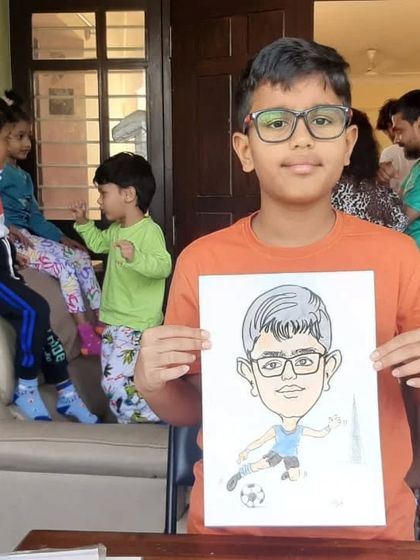 This young soccer fan is happy with his caricature, a great return gift from a birthday party.