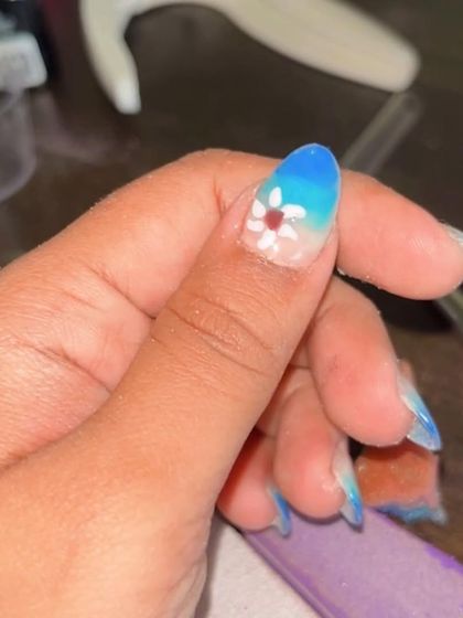 Another shot of the finished blue ombré nail with the hand-painted flower. It's a perfect look for summer or a beach vacation.