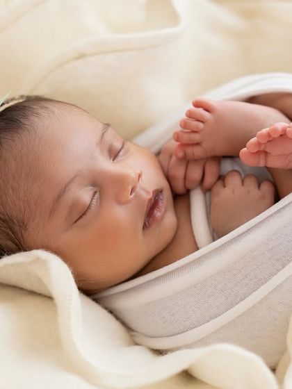 A close-up of another baby in the bloom setup, this time with a tiny floral headband. I love how this pose shows off their little hands and feet.