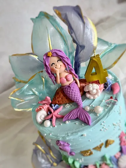 A close-up of the adorable, winking mermaid topper.