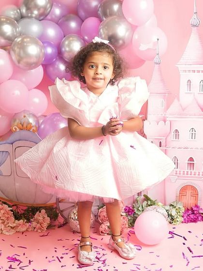 A solo portrait of one of the princesses, standing confidently in her magical kingdom.