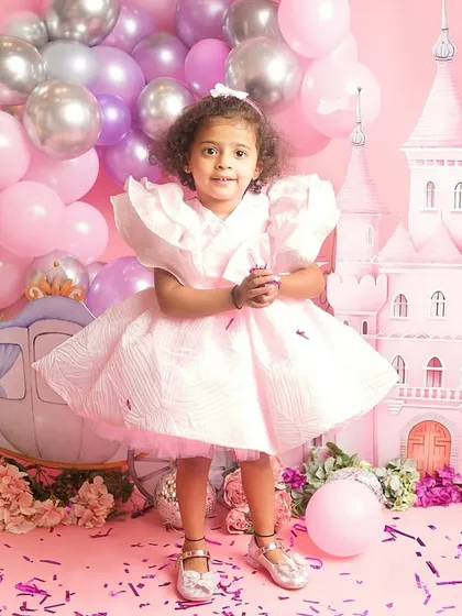 A solo portrait of one of the princesses, standing confidently in her magical kingdom.