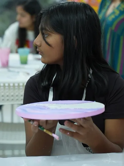 A participant works on her art piece in the studio. My workshops provide a welcoming space for everyone to explore their creativity.