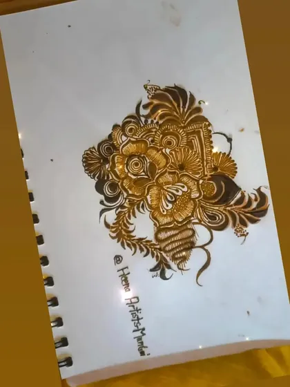 A beautiful floral bunch sketched in my practice book. This is where I work out new compositions and details before applying them to a client's hand.