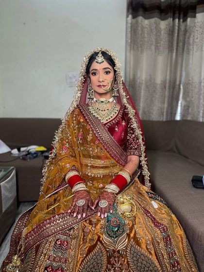 A full-length view of Sarab's unique and beautiful bridal outfit. The makeup was designed to complement the rich colors and heavy embroidery.