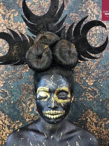 A spooky and intricate Halloween makeup look, featuring a skull design and a dramatic black hairstyle.