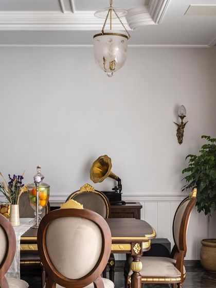 A detail from a timeless dining room, where a vintage gramophone and classic furniture set the tone for elegant family gatherings. Every detail is crafted to inspire connection.