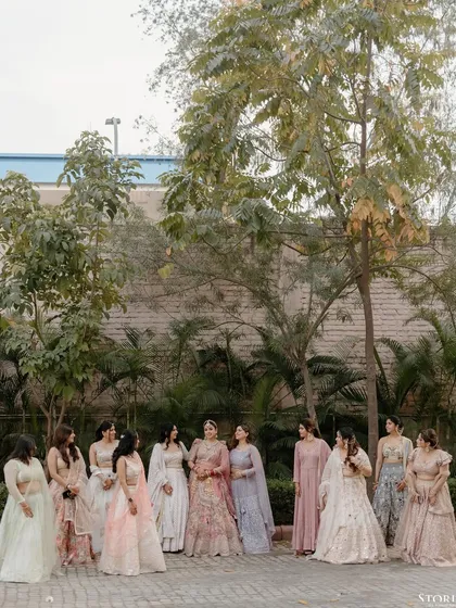 The bride, Riya, surrounded by her bridesmaids, sharing a moment of friendship and celebration.