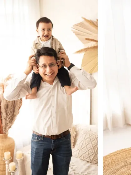 A father gives his laughing son a shoulder ride. We love capturing the fun and playful side of your family's relationship.