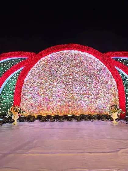 The intricate details of the floral arches, featuring a mix of red, pink, and white flowers against a green base, creating a stunning visual impact.